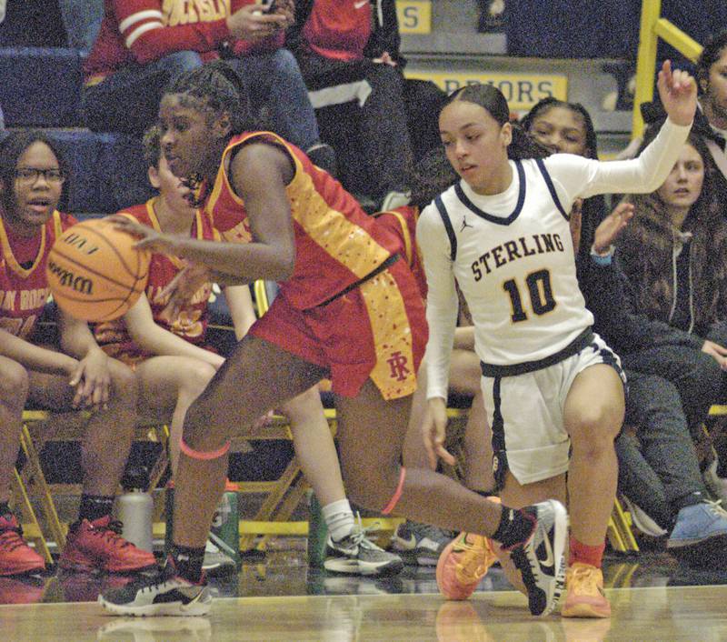 Sterling player Nia Harris attempts to get the ball from a Rock Island player. Western Big 6 conference champions Sterling hosted Rock Island in girls basketball. The action took place Thursday, February 13, 2025 at Musgrove Fieldhouse at SHS.