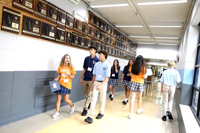 Nazareth Academy student leaders show freshmen around the halls La Grange Park school during freshman orientation on Thursday, Aug. 17, 2023.