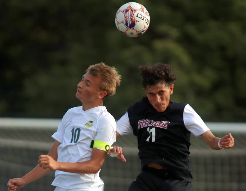 Crystal Lake South’s  Nick Prus, left, battles Prairie Ridge’s Anthony Castro, right, in varsity soccer on Thursday, Sept. 19, 2024, at Prairie Ridge High School in Crystal Lake.