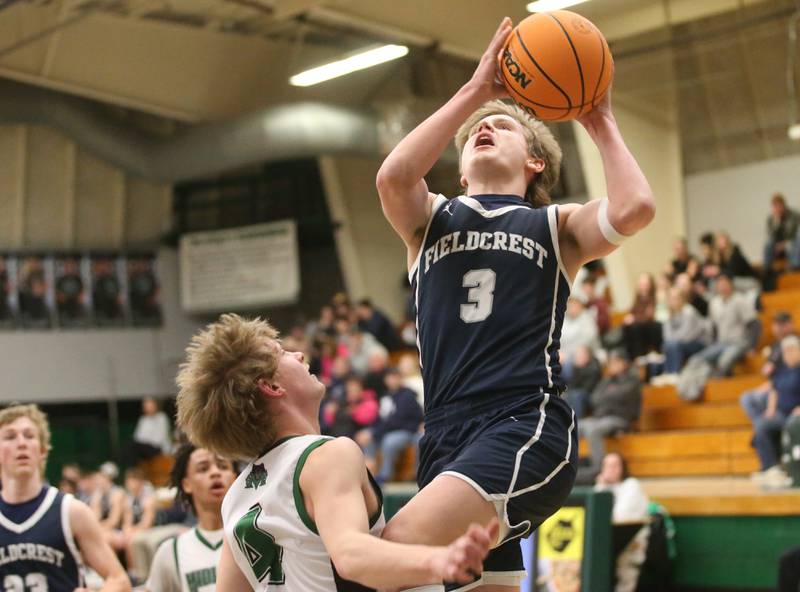 Fieldcrest's Eddie Lorton drives to the hoop as Midland's Deshawn Brown defends on Wednesday, Feb. 19, 2025 at Midland High School.