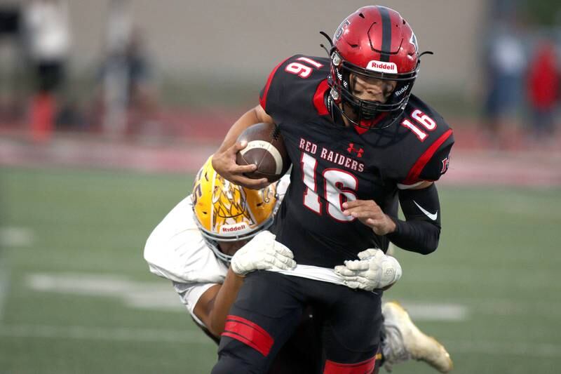 Huntley’s quarterback Braylon Bower runs the ball against Jacobs in varsity football in Huntley Friday night.