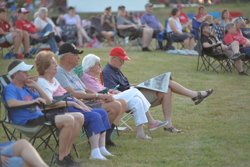 Andrew Reckmeyer and his mom, Carol, (center) were two of the hundreds of people who listened to the Kable Concert Band's patriotic program prior to the fireworks at Let Freedom Ring on Friday, July 4, 2025 in Mt. Morris. Andrew and Carol, former Mt. Morris residents, were back for Andrew's 50th reunion for Mt. Morris High School's Class of 1975. Carol and her late husband, Warren, taught music in the school district for many years.