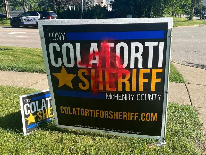 Tony Colatorti campaign sign spray painted with an anti-government symbol.