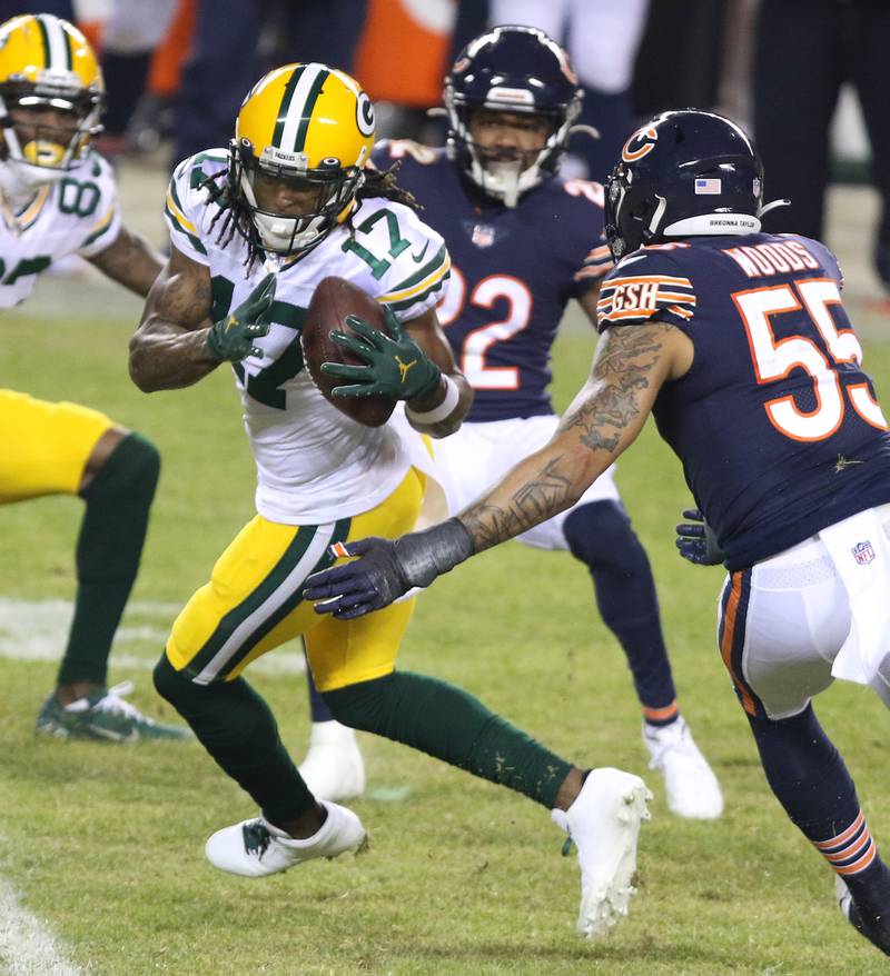 Green Bay Packers wide receiver Davante Adams (17) makes a catch in front of Chicago Bears linebacker Josh Woods (55) and Chicago Bears cornerback Kindle Vildor (22) during their game Sunday at Soldier Field in Chicago.