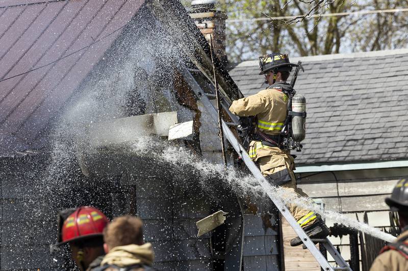 Firefighters work at the scene of a house fire at 204 East 11th Street in Rock Falls Wednesday, May 1, 2024.