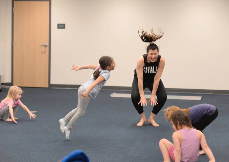 Leah Vaughan of La Grange Park and children ages pre K -2nd participate in Earth Day Yoga at La Grange Park Library Sunday April 13, 2025. The event was held to celebrate Earth Day and included them pretending to be various animals including a frog.