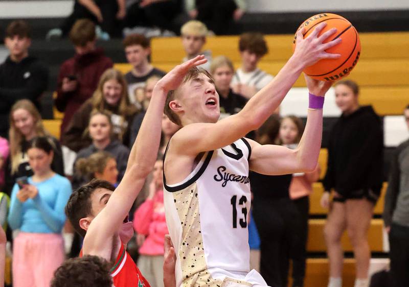 Sycamore's Xander Lewis goes to the basket in front of La Salle-Peru's Nick Olivero during their game Tuesday, Feb. 4, 2025, at Sycamore High School.