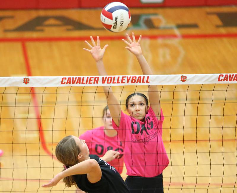 L-P's Ava Currie looks to block Ottawa's Ayla Dorsey spike during Volley for a Cure night on Tuesday, Oct. 1, 2024 at AJ Sellett Gymnasium.