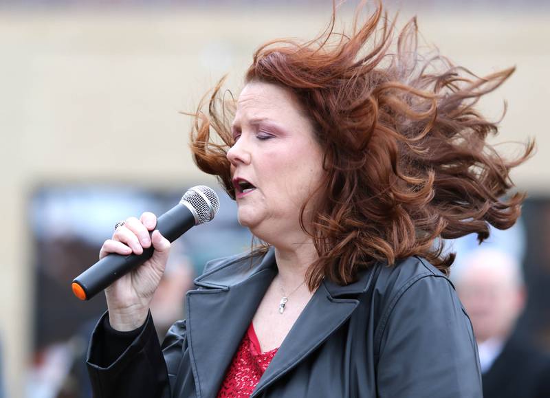 Teri Crain Goodman performs the "Battle Hymn of the Republic" on a windy and cold Thursday, Nov. 11, 2021, during a Veterans Day and Soldiers' and Sailors' Memorial Clock rededication ceremony at Memorial Park in downtown DeKalb.