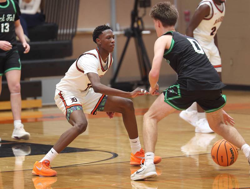 DeKalb's Gabriel Crump plays defense against Rock Falls' Max Burns during their game Tuesday, Dec. 2, 2025, at DeKalb High School.