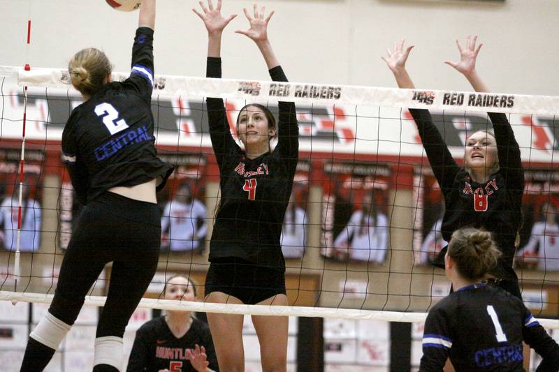Huntley’s  Diellza Sejdini, center, and Summer Massow, right, block as Burlington Central’s Haidyn Schatz hits the ball in varsity volleyball at Huntley High School in Huntley on Thursday, Oct. 24, 2024.