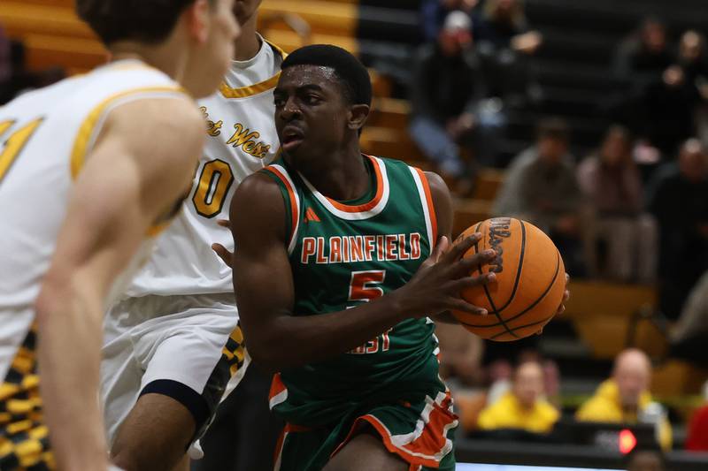 Plainfield East’s Christopher Tchoffa drives to the basket against Joliet West on Friday, Dec. 19, 2025 in Joliet.