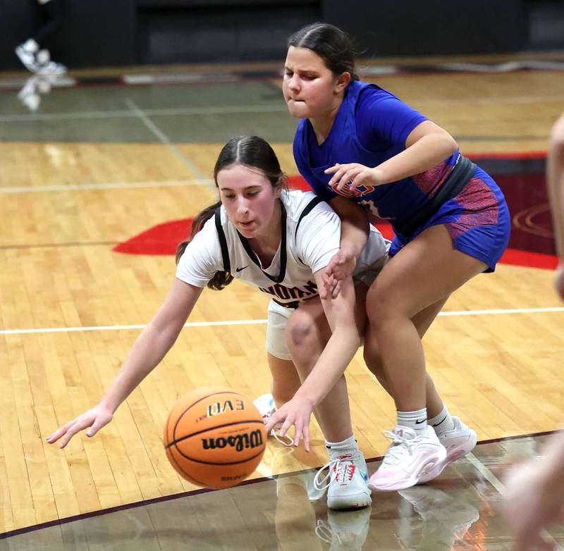 Indian Creek's Elsie Betz and Genoa-Kingston's Ayva Hernandez go after a loose ball Monday, Dec. 8, 2025, during their game at Indian Creek High School in Shabbona.