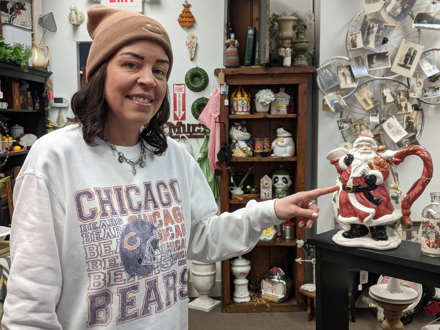 Otts & Ends founder Stephanie Ott shows one of the Old World Santa items for sale at the store.