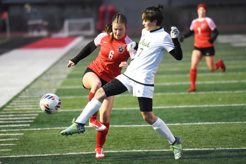Bradley-Bourbonnais' Lilly Argyelan, left, has the ball poked away from her by Bishop McNamara's Lily Walker-Dionne during a game at Bradley-Bourbonnais Tuesday, April 1, 2025.