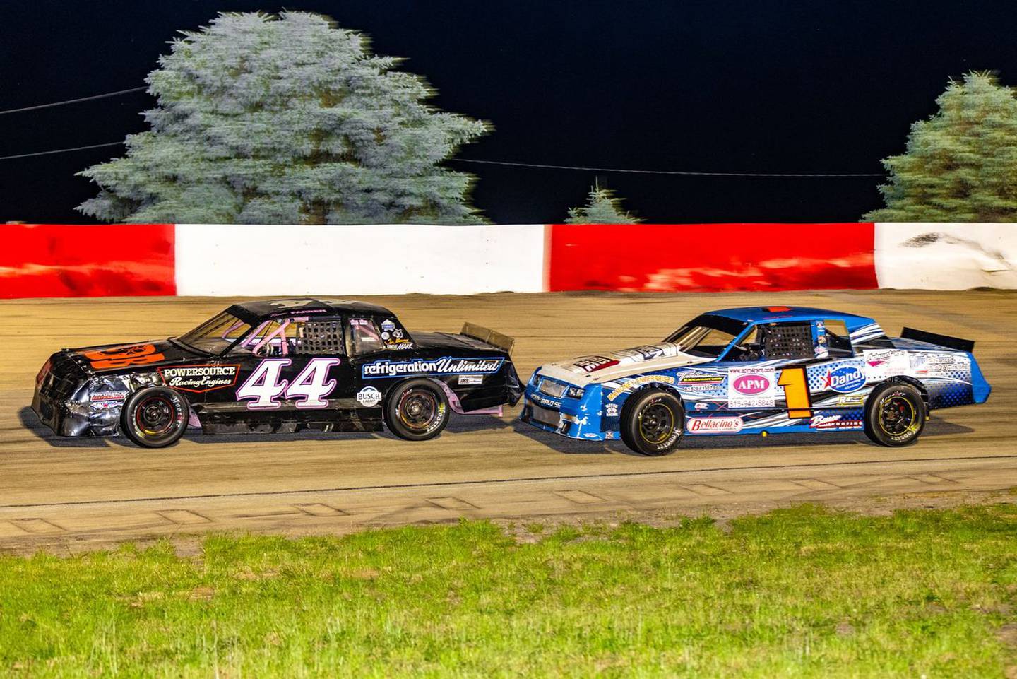 Renee Farren, in the 44 car, and Randy Weeze, in the 1 car, battle during a street stock heat race.