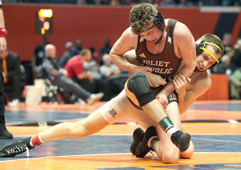 Sycamore’s Gus Cambier (right) wrestles Joliet Catholic’s Connor Cumbee in the Class 2A 152 pound 3rd place match Saturday, Feb. 18, 2023, in the IHSA individual state wrestling finals in the State Farm Center at the University of Illinois in Champaign.