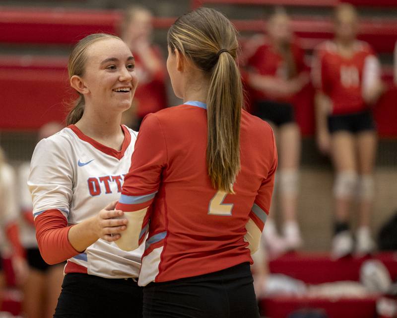 (from left) Ashlynn Ganiere (9) of Ottawa comforts teammate Meredith Waldron (2) after missing hit on Thursday, Sept. 18, 2025 at Ottawa High School in Ottawa.