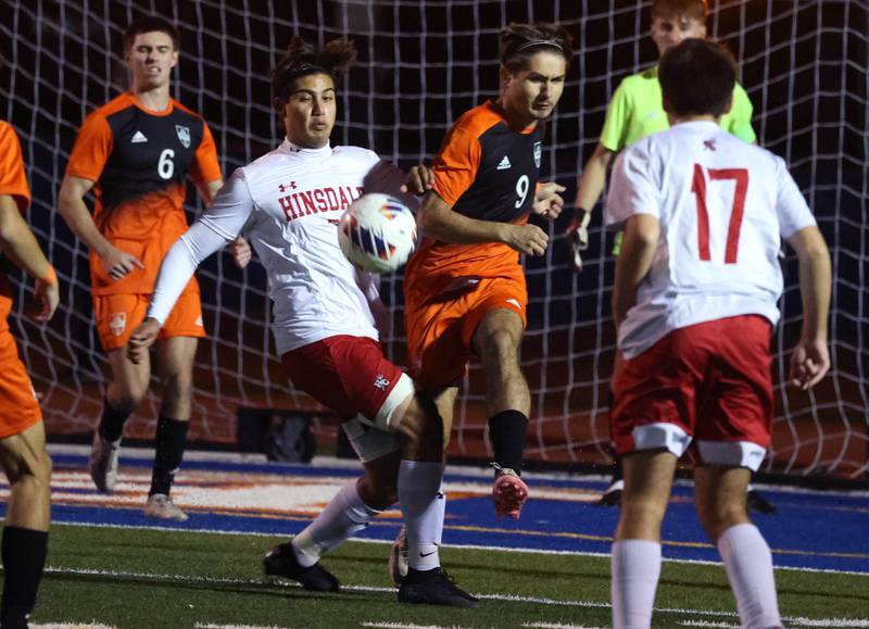 Hersey's Ray Reyes kicks the ball away from Hinsdale Central's Enzo Cinque Friday, Nov. 8, 2024, during their Class 3A state semifinal game at Hoffman Estates High School.
