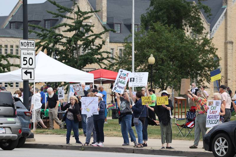 Protesters interact with a passing car honking in support during a "Good Trouble Lives On" rally held in Kankakee as part of a national day of peaceful protests on Thursday, July 17, 2025.