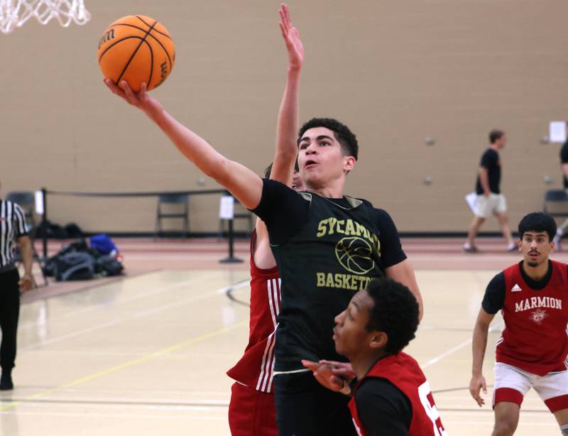 Sycamore’s Marcus Johnson goes to the basket Friday, June 20, 2025, during their game against Marmion in the DeKalb Live summer tournament at DeKalb High School.