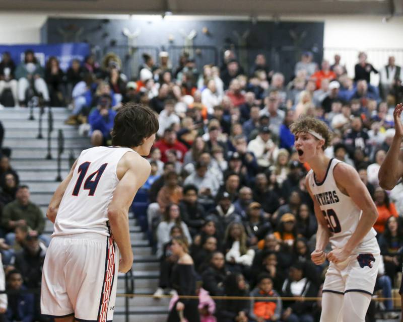 Oswego's Niko Jurkovic (14) celebrates his basket with Brayden Borrowman (30) during their basketball game between Oswego East at Oswego Friday, Jan 9, 2026 in Oswego.