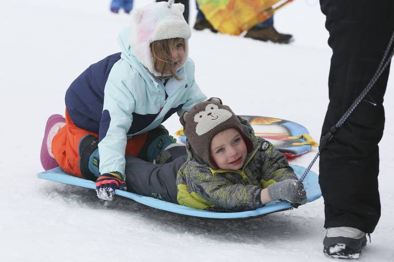 Syrus Buonicore and his sister Elsa get pulled up the hill on Sunday, Jan. 31, 2021, at Cene's Four Seasons Park in Shorewood, Ill. Nearly a foot of snow covered Will County overnight, resulting in fun for some and challenges for others.