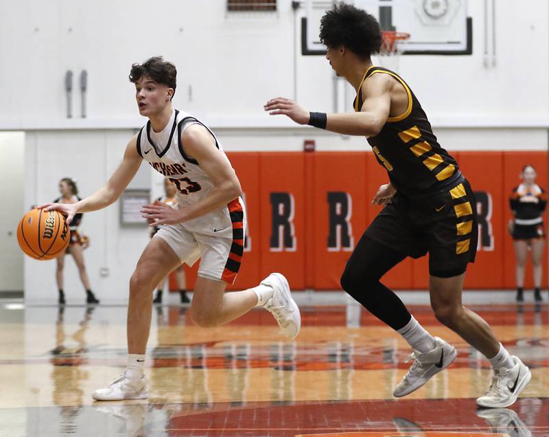 McHenry's Marko Stojich brings the ball up the court against Jacobs' Jordan O'connor during an IHSA Class 4A McHenry Regional basketball game on Wednesday, Feb. 26, 2025, at McHenry High School.
