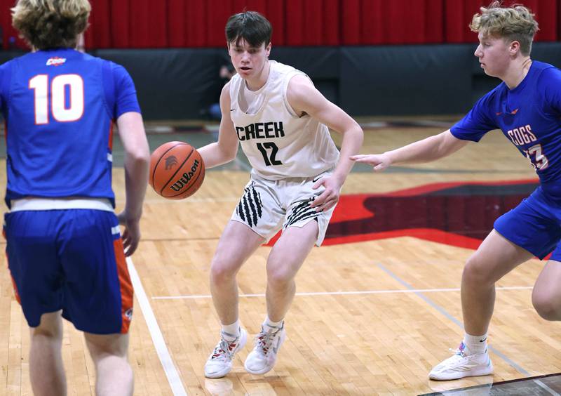 Indian Creek's Jakob McNally dribbles between Genoa-Kingston's Nathan Kleba and Hayden Hodgson Wednesday, Jan. 25, 2023, at Indian Creek High School in Shabbona.