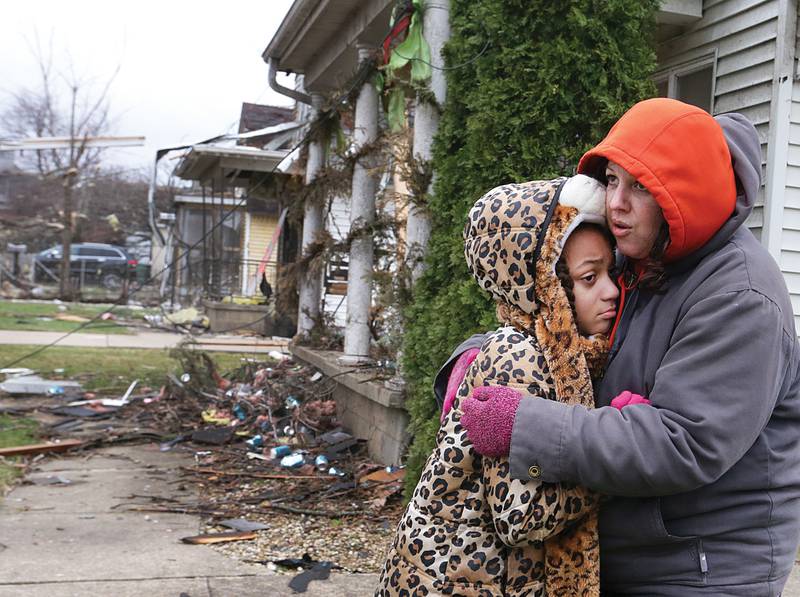 Valerie McAvoy, hugs her daughter Olivia after their home on 19th street in Naplate was destroyed by a tornado on Wednesday, Feb 28, 2017 in Naplate. Around 50 homes had damage in the town of Naplate. The south side of Ottawa also had homes with structural damage.