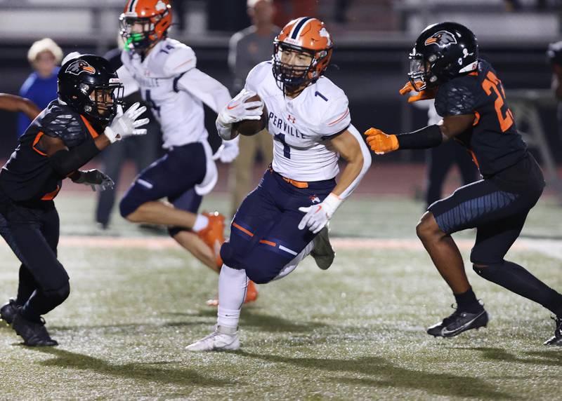 Naperville North's Cole Arl splits two DeKalb defenders on his way to a touchdown during their game Friday, Sept. 22, 2023, at DeKalb High School.