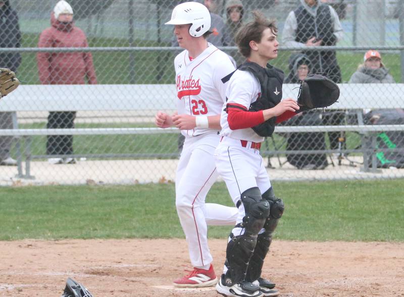 Ottawa's Jackson Mangold scores a run as Hall catcher Greyson Bickett waits for the late throw on Tuesday, April 1, 2025 at Ottawa High School.