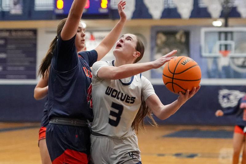 Oswego East's Maggie Lewandowski (3) shoots the ball in the post against Oswego’s Kendall Grant (42) during a basketball game at Oswego East High School on Saturday, January 14, 2017.