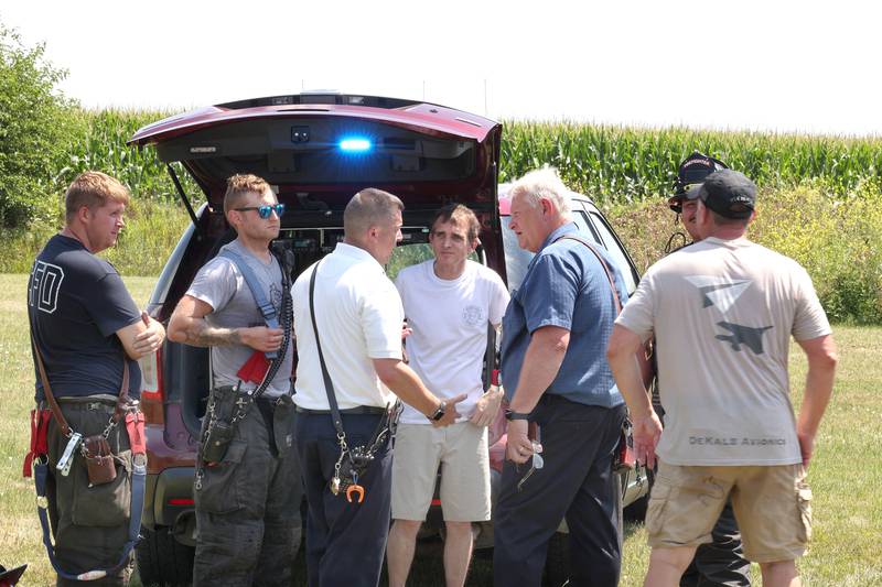 First responders from DeKalb and Cortland talk at the scene of a plane crash Thursday, July 27, 2023, behind a business at 260 West Lincoln Highway in Cortland.