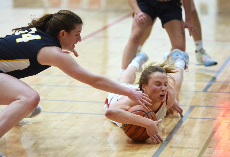 Benet's Lenee Beaumont hits the deck going after a loost ball with Neuqua Valley's Nalia Clifford (24) during Tuesday’s IHSA Class 4A regional semifinal girls basketball game in Aurora.