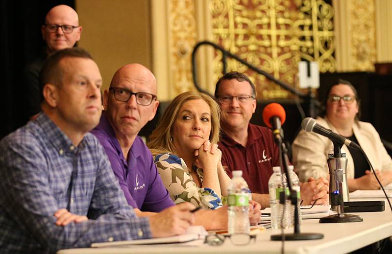 Carus leadership team members (front from left) Todd Courter, Richard Landtiser, Chryss Crockett, Allen Gibbs, Lyndsay Bliss and Andy Johnston (standing) attend the Carus town hall meeting on Wednesday, May 10, 2023 in Matthiessen Auditorium at LaSalle-Peru Township High School