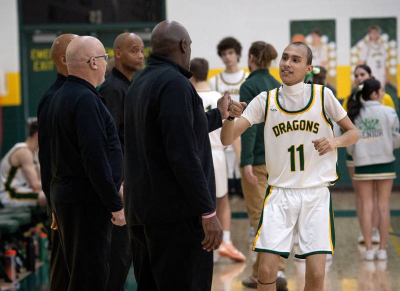 Grant Park's Luis Maldonado, right, greets the officials before the start of a game against Momence on Friday, January 16, 2026.
