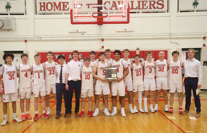 Members of the L-P boys basketball team hold the Class 3A Regional title plaque after defeating Ottawa on Wednesday, Feb. 25, 2026 in Sellett Gymnasium at L-P High School.