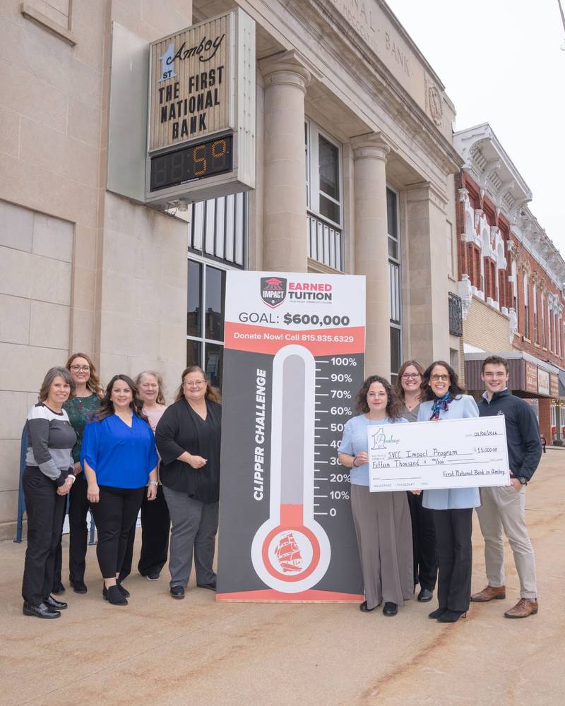 The Sauk Valley Community College Clippers Impact Challenge received a generous $15,000 pledge. Community members can view the fundraising thermometer located at The First National Bank in Amboy. Pictured are Tina Eller (from left), Angie Dallam, Elsa Payne, Judy Jones, Lisa Bickett, Lori Cortez, Sarah Wittenauer, Colleen Henkel and Noah Grot.