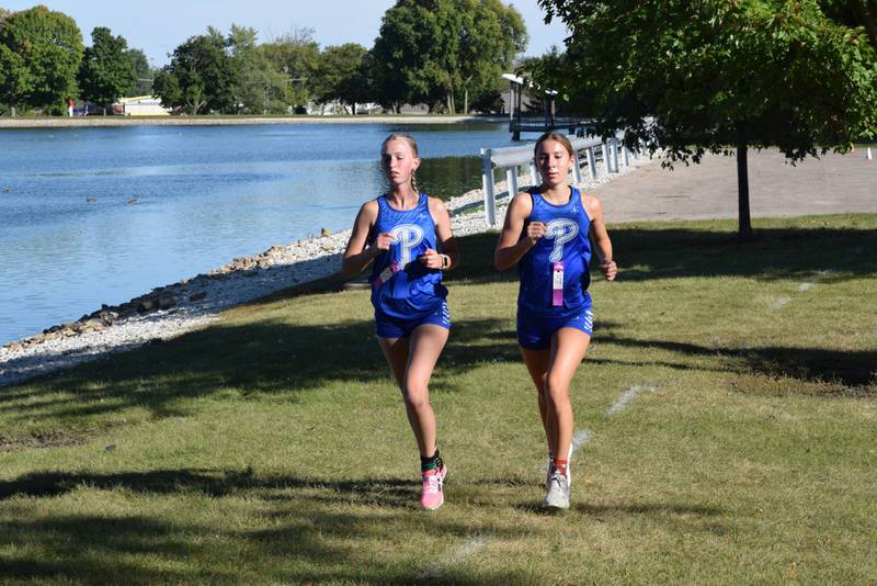 Princeton's Payton Frueh (left) and Ruby Acker run in Wednesday's meet at Lake Mendota. Acker finished first and Frueh was second.