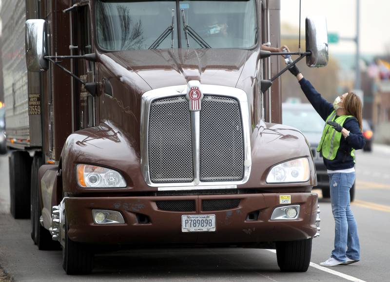 Volunteer Kelli Hurley hands out boxed lunches to truck drivers traveling through Campton Hills on April 3. The lunches were sponsored by several area businesses and arranged by Campton Hills K9 Officer James Levand