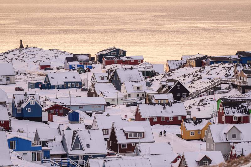People walk on a street in Nuuk, Greenland, Wednesday, Jan. 14, 2026. (AP Photo/Evgeniy Maloletka)