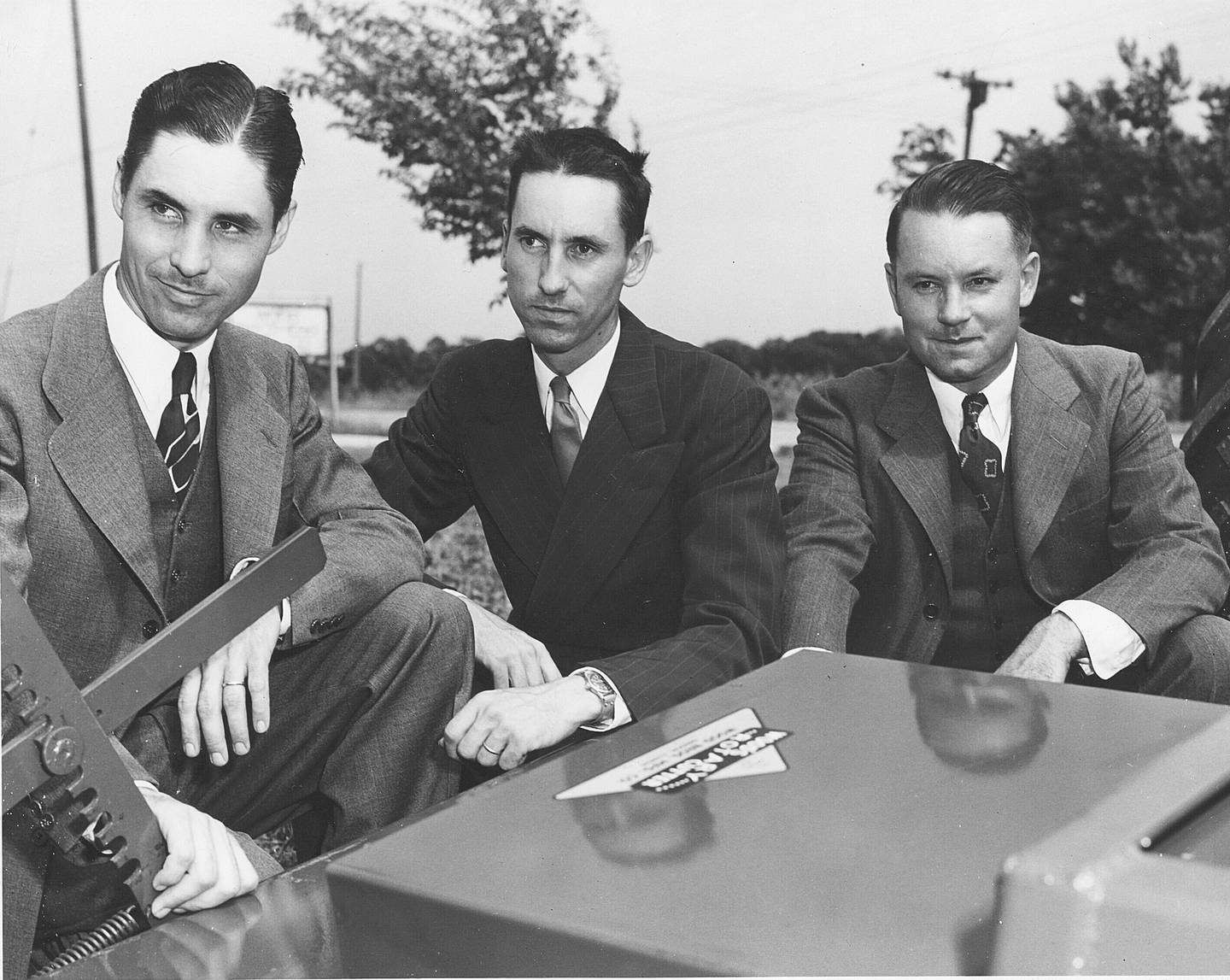 The Woods Brothers – (from left) Keith, Leonard and Mervel – pose for a 1951 photo next to one of their machines at its Oregon facility.