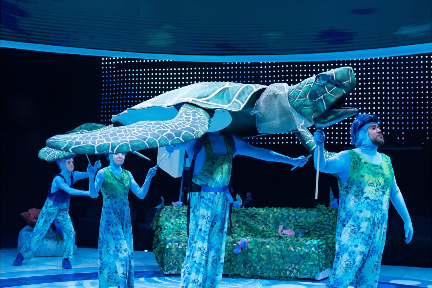 Charlie Scott Long (left) helps puppeteer a giant sea turtle in Finding Nemo the Musical.