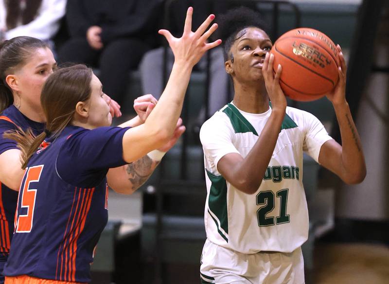 Kishwaukee College's Raven Meeks goes to the basket against Highland Community College's Sarah Kempel during their game Thursday, Jan. 11, 2024, at Kishwaukee College in Malta.