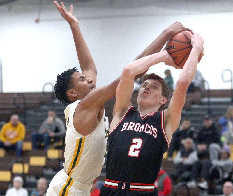 Crystal Lake South’s  Christian Rohde, left, guards a shot by Barrington’s Adam Baird in Hinkle Holiday Classic boys basketball tournament game action at Jacobs High School Tuesday.