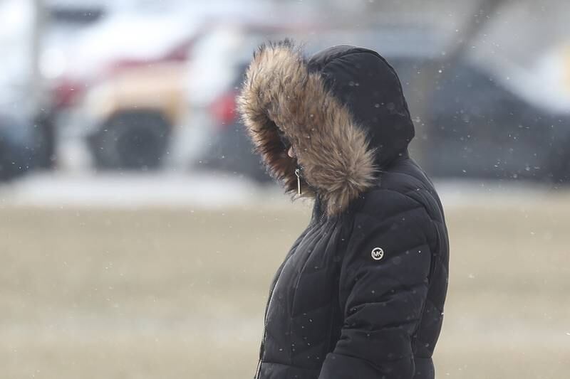 A pedestrian bundles up as they walk along West Jefferson Street in downtown Joliet on Wednesday, Jan. 22, 2025.