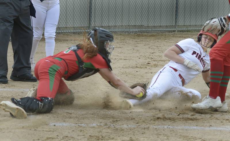 Ottawa’s Piper Lewis (at right) gets in under the tag of La Salle-Peru catcher Addison Duttlinger to score in the first inning of the Pirates' 13-5 victory Wednesday, May 8, 2024, at King Field in Ottawa.