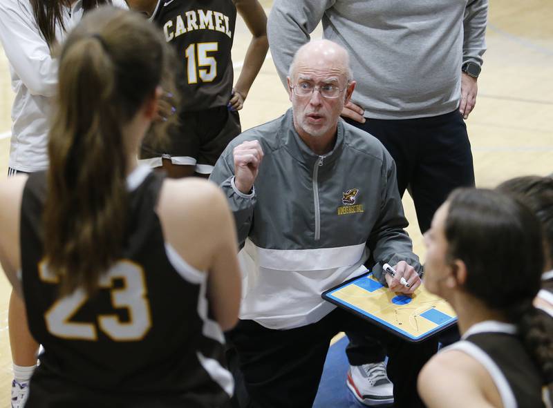 Carmel coach Ben Berg talks to the team during the girls varsity basketball game between Carmel High School and Nazareth Academy on Wednesday, Dec. 7, 2022 in LaGrange, IL.