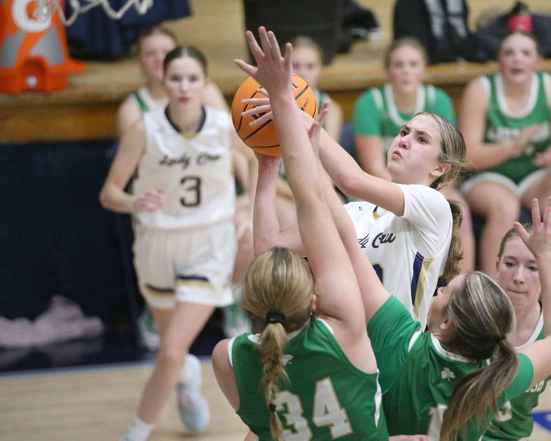 Marquette's Kaitlyn Davis eyes the hoop as Seneca's Tessa Krull and Alyssa Zellers defend on Thursday, Dec. 5, 2024 in Bader Gym at Marquette High School.